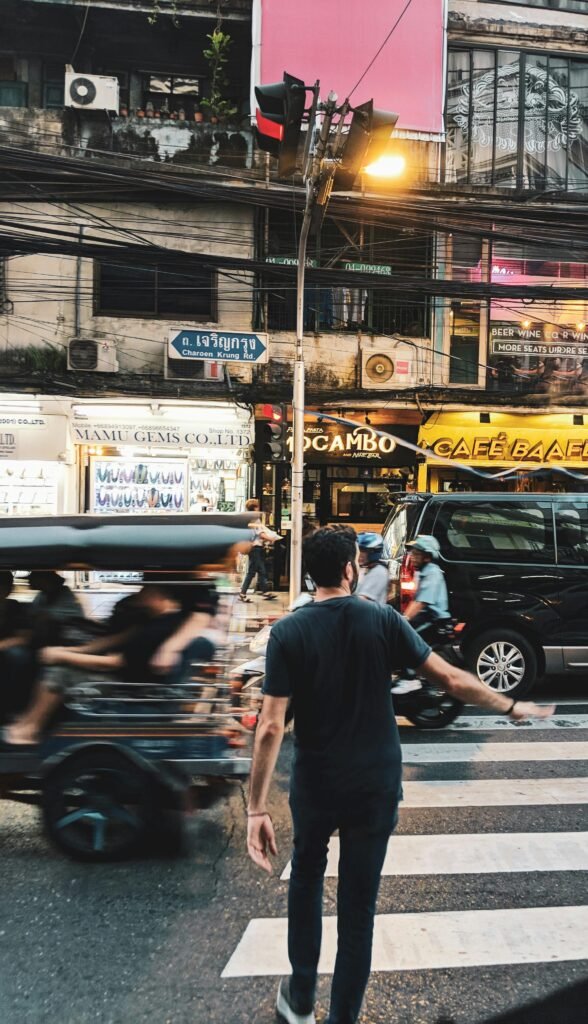 Vibrant pedestrian crossing in Khwaeng Suriya Wong, Bangkok, capturing urban life and motion.