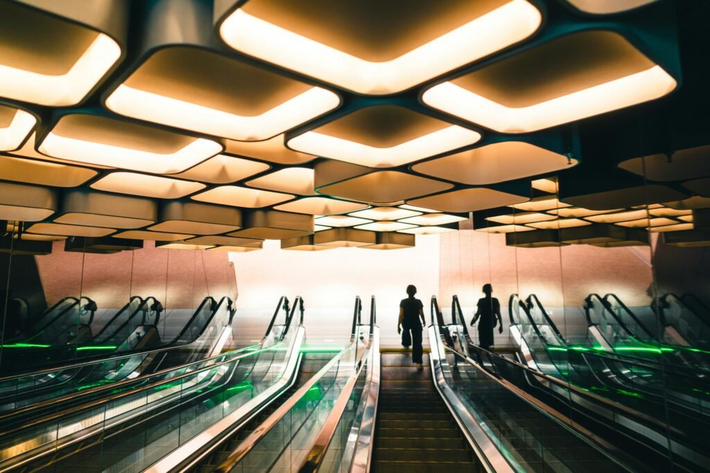 Futuristic design of an interior escalator in Bangkok with striking lighting effects.